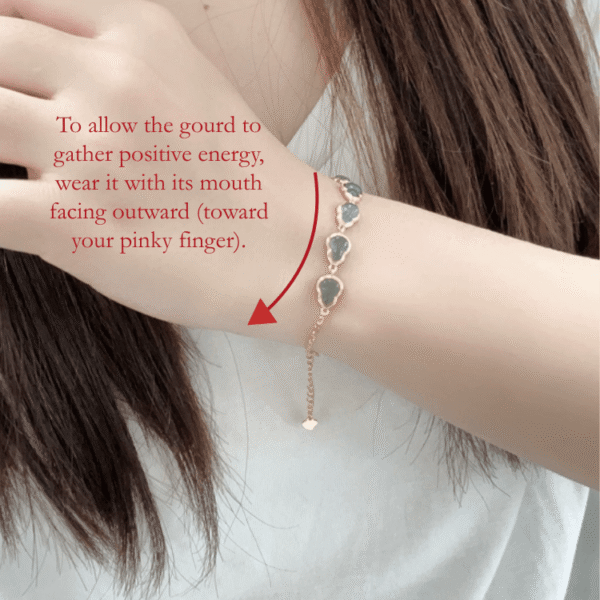 RUYI Jewelry wearing guide for Water Element "Lan Shui" (blue toned)Jadeite hulu bracelet. Shows the correct orientation: the hulu (gourd) opening should face the little finger, traditionally believed to enhance wisdom and flow.