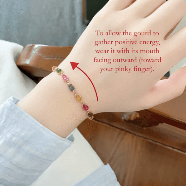 RUYI Jewelry Talisman Hulu bracelet wearing guide， hand detail. Illustrates the traditional belief that the hulu (gourd) opening should face the little finger to receive positive energy.